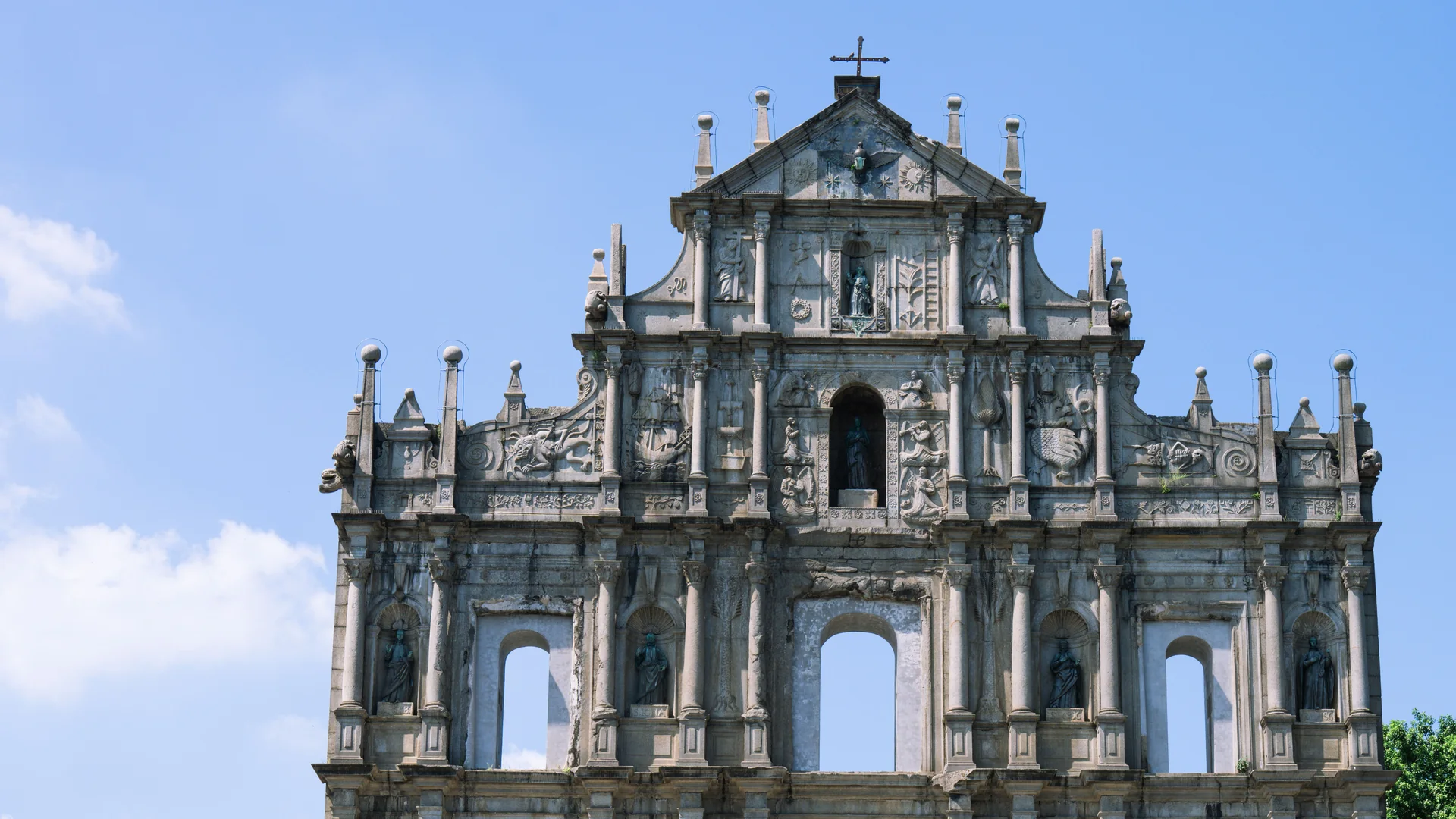 The stone facade of the Ruins of St Paul's, Macau's best-known landmark, against a blue sky